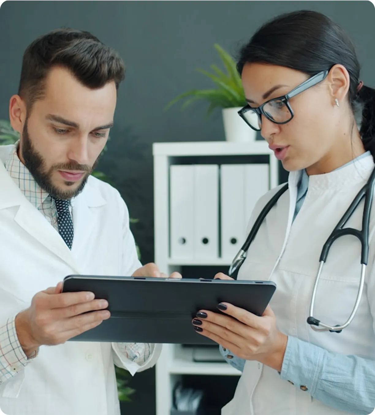 Doctors analyzing genetics data on tablet